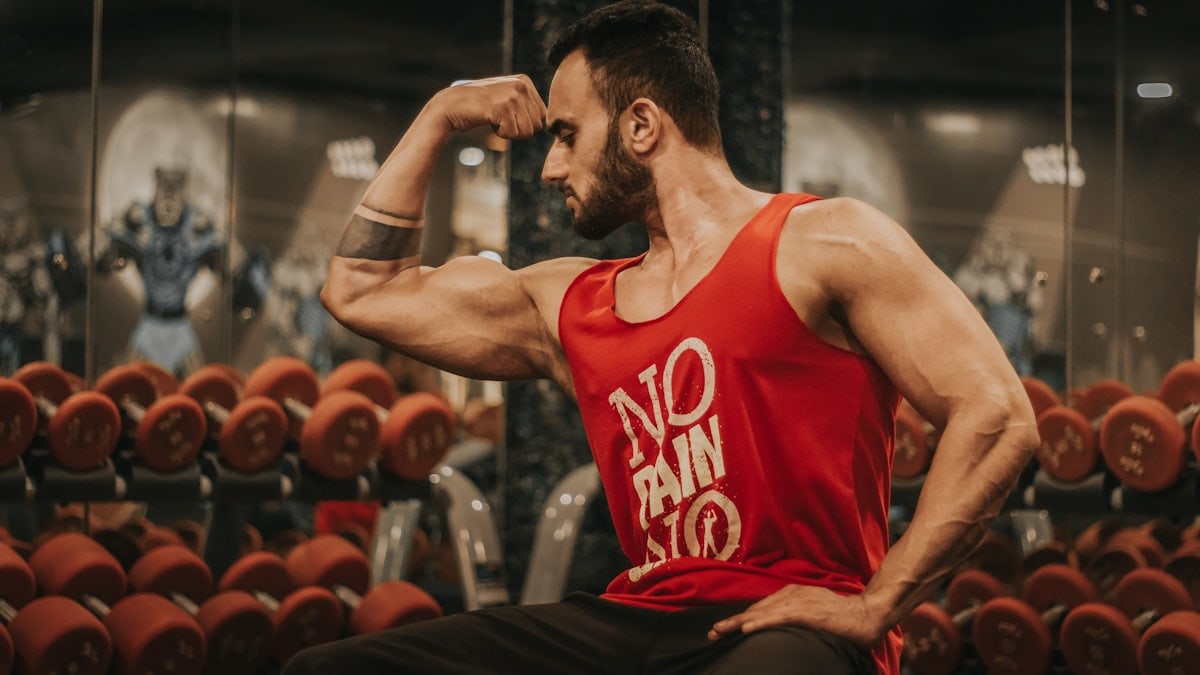 man in red tank top sitting on chair